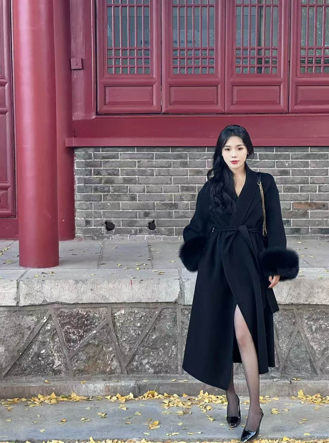 Front view of a black wrap-style premium coat