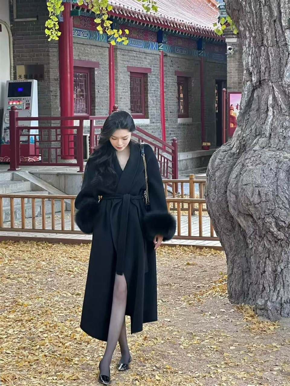 Black belted cashmere coat with statement cuff trim